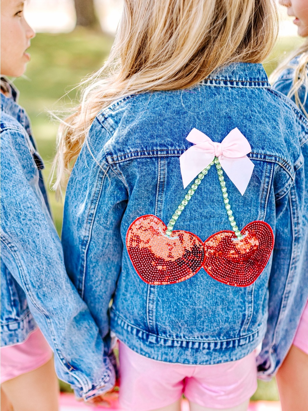 Girls' Blue Denim Jacket with Red Sequin Cherry Patch and Pink Bow Accent
